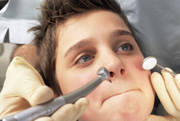 Boy refusing to open mouth for dentist